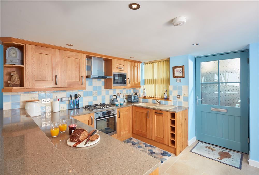 Ground floor: Open-plan living space with well-equipped kitchen and sit up breakfast bar at The Old Smoke House, St Austell 