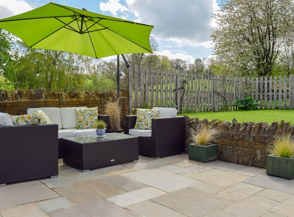 Delightful patio with seating area at The Old Stables in Swerford, near Chipping Norton, Oxfordshire