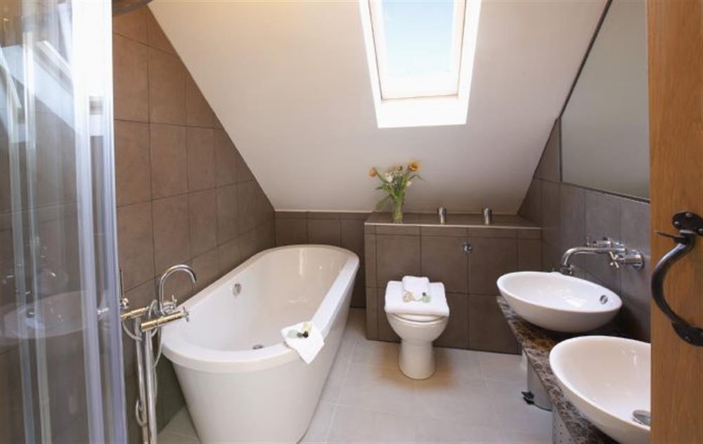 Bathroom with bath, shower, twin basins and wc at The Old Stables (Wiltshire), Gastard