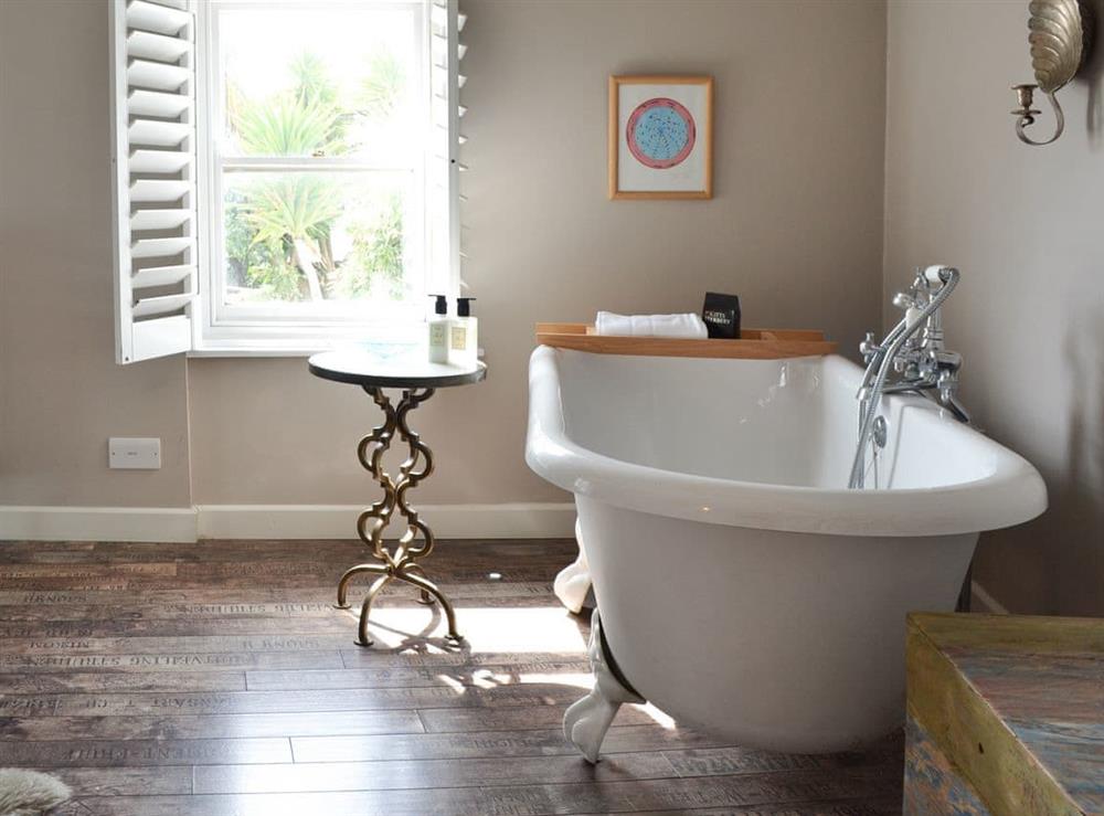 Free-standing bath within the double bedroom at The Old Stores in Mousehole, near Penzance, Cornwall