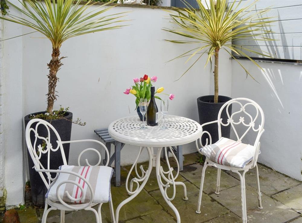 Patio area with outdoor furniture at The Old Stores in Mousehole, near Penzance, Cornwall