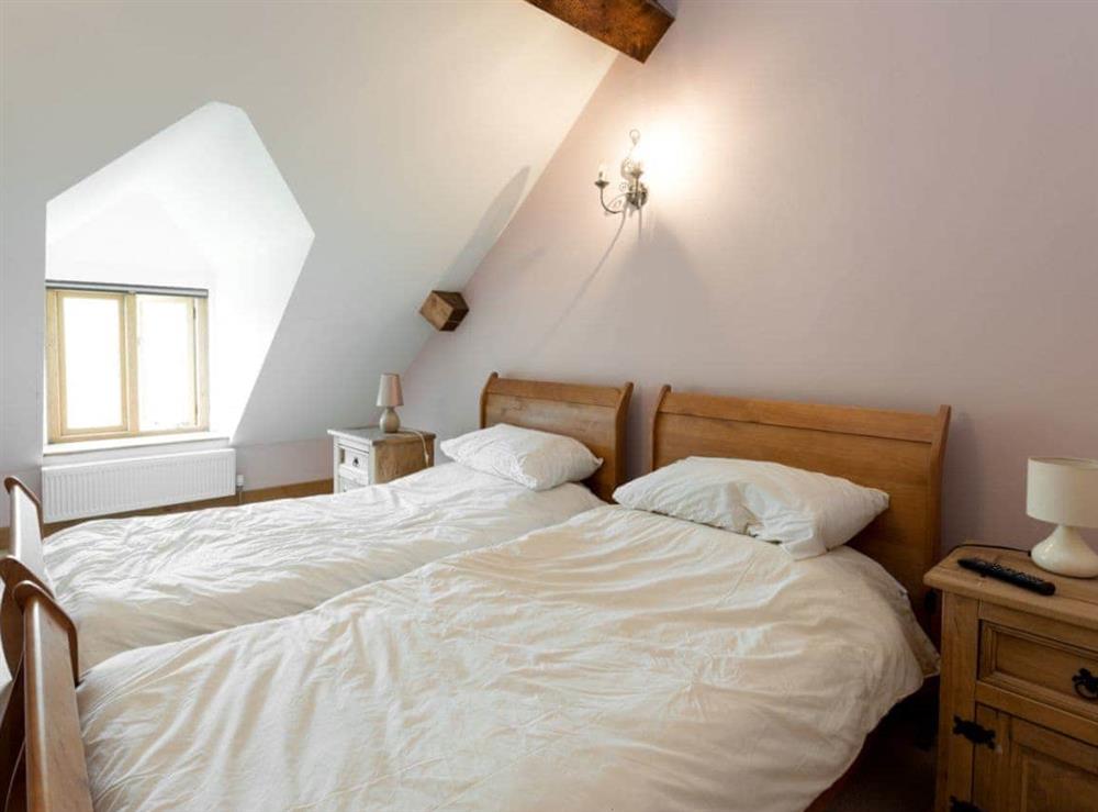 Twin bedroom at The Old Tithe Barn in Litton Cheney, near Dorchester, Dorset