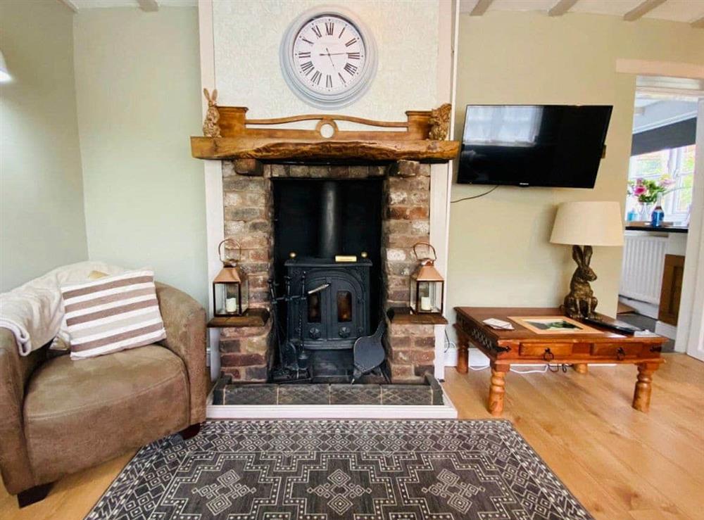 Welcoming living room with wood burner at The Old Toll House in Coalport, near Ironbridge, Shropshire