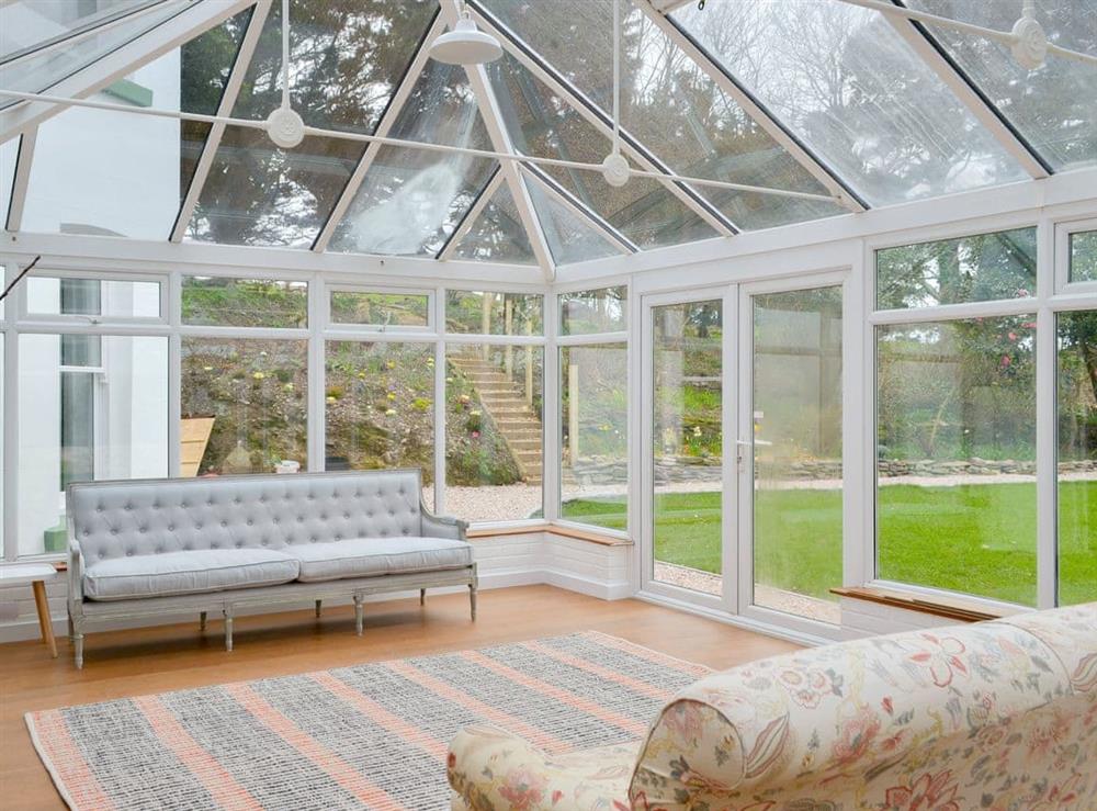 Huge conservatory overlooking the garden at The Old Vicarage in Talland Bay, near Looe, Cornwall