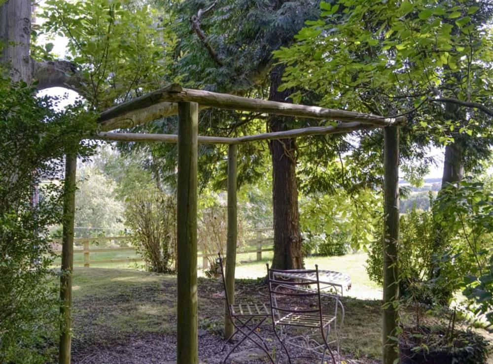Additional seating area within garden at The Old Winery Cottage in Newent, Gloucestershire