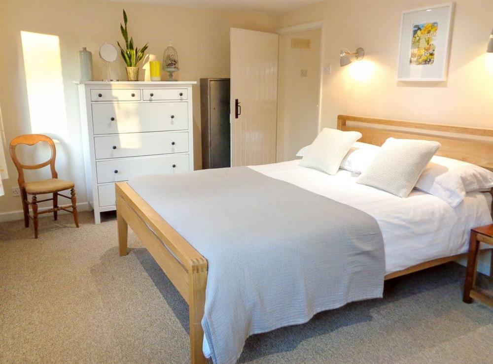 Comfortable king size bedroom with garden views at The Old Winery Cottage in Newent, Gloucestershire