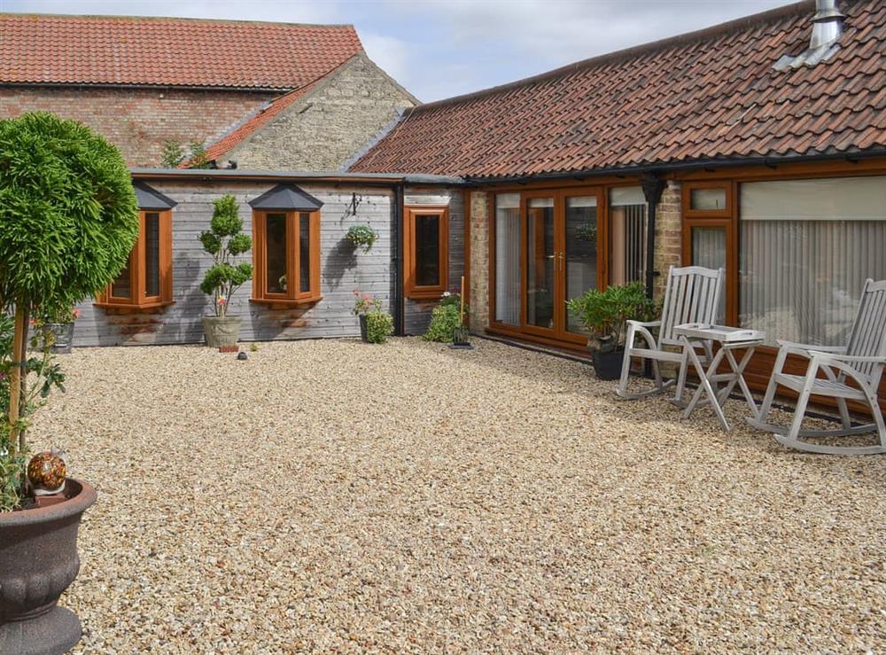 Enclosed courtyard with sitting-out area, at The Olde Barn in Welton, near Lincoln, Lincolnshire
