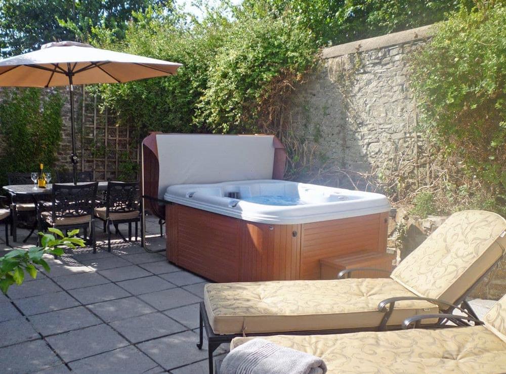 Inviting hot tub in courtyard at The Orangery in Bideford, Devon