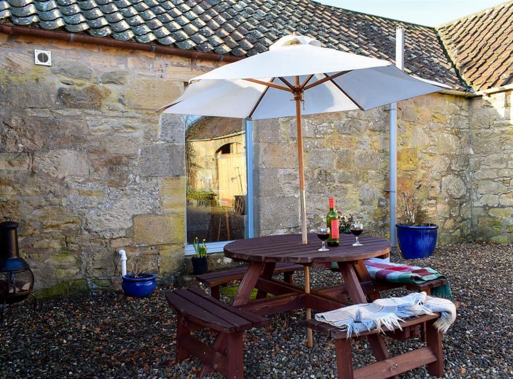 Bright courtyard with garden furniture at The Outside Room in Near Ladybank, Cupar, Fife