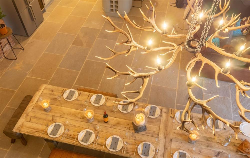 Beautiful handmade dining table with impressive chandelier made with  shed antlers