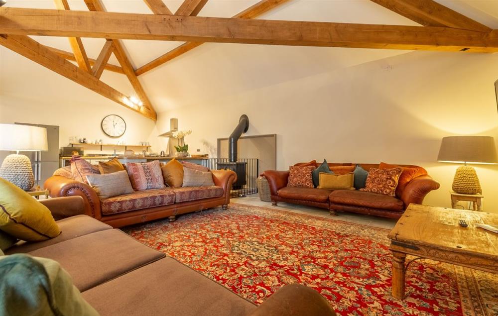 Spacious open plan sitting room with wood burning stove