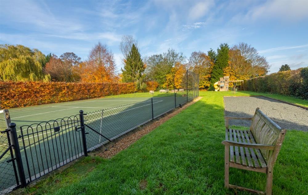 Tarmac tennis and petanque courts at The Owl House, Little Massingham