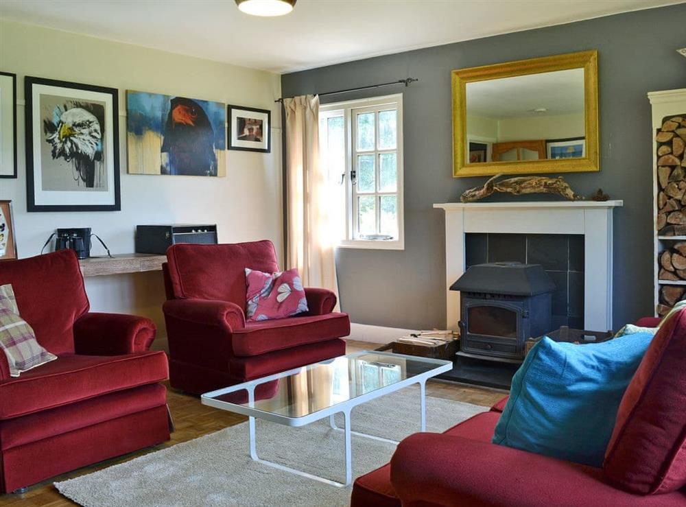 Stylishly furnished living room with wood burner at The Paint Box in Heasley Mill, near South Molton, Devon