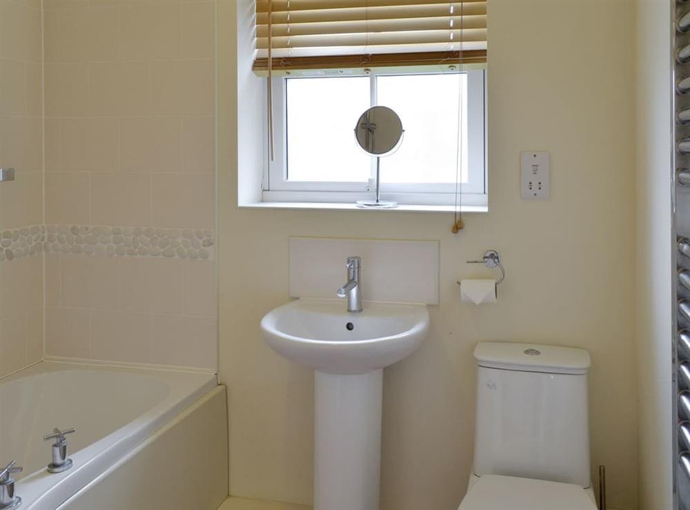 Bathroom with shower over bath at The Parade Apartment in The Bay, Filey, North Yorkshire