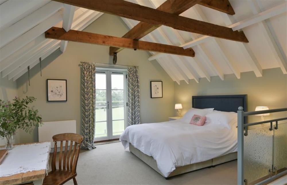 Open-plan bedroom with 5’ king-size bed and en-suite bathroom area at The Parlour, Freston