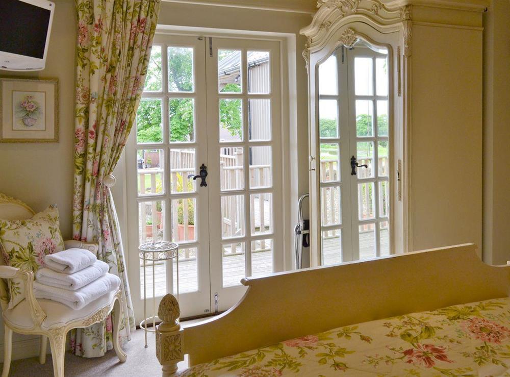 Double bedroom with French doors to terrace at The Pavilion in Killerby, near Scarborough, N. Yorks., North Yorkshire