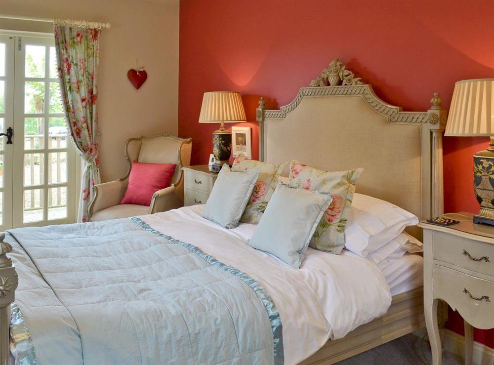 Master bedroom with French doors to terrace at The Pavilion in Killerby, near Scarborough, N. Yorks., North Yorkshire