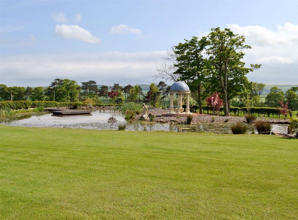 Mature garden with lake at The Pavilion in Killerby, near Scarborough, N. Yorks., North Yorkshire