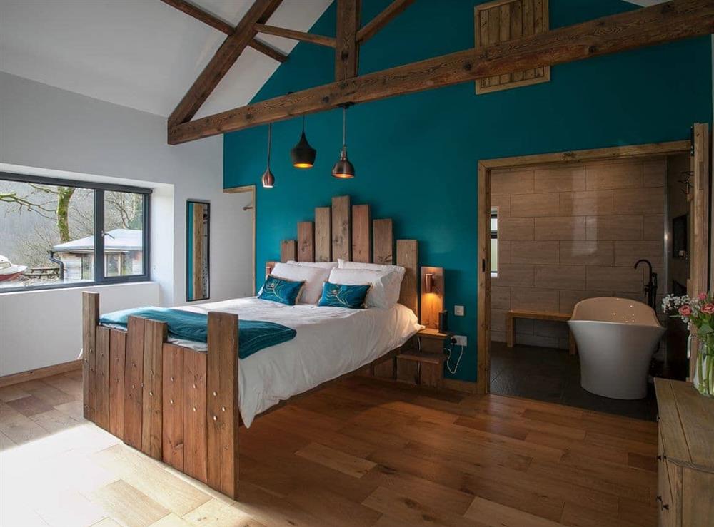 Beautiful bedroom with king size bed and en-suite at The Pendre Longbarn in Pontrhydygroes, near Ystrad Meurig, Cardigan, Dyfed