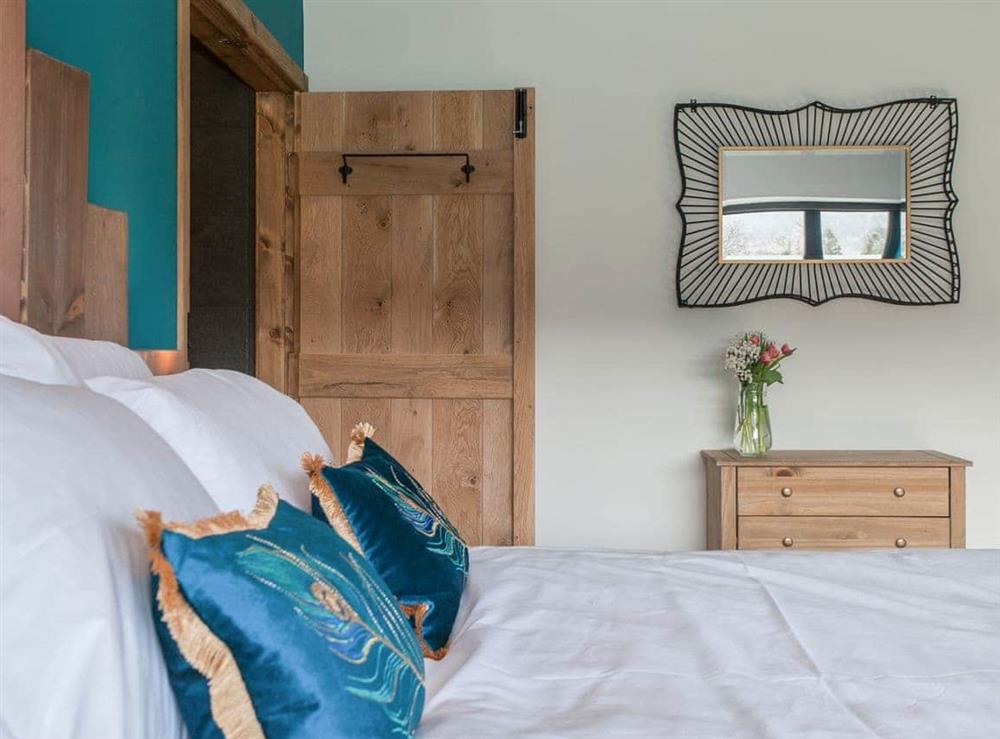 Relaxing bedroom with king size bed at The Pendre Longbarn in Pontrhydygroes, near Ystrad Meurig, Cardigan, Dyfed