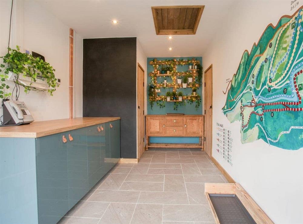 Utility room with laundry facilities and detailed local map of walks available on the estate