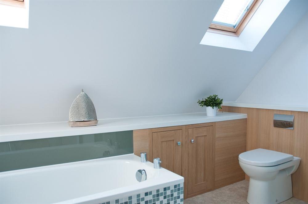 En suite bathroom with bath and separate shower cubicle at The Penthouse (Woodside) in Bennett Road, Salcombe