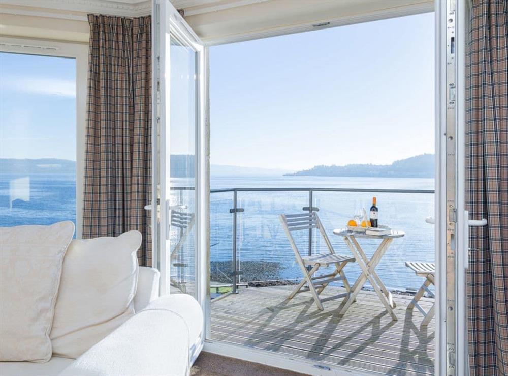French doors open onto a sun-drenched balcony with fine views at The Penthouse in Strone, near Dunoon, Argyll