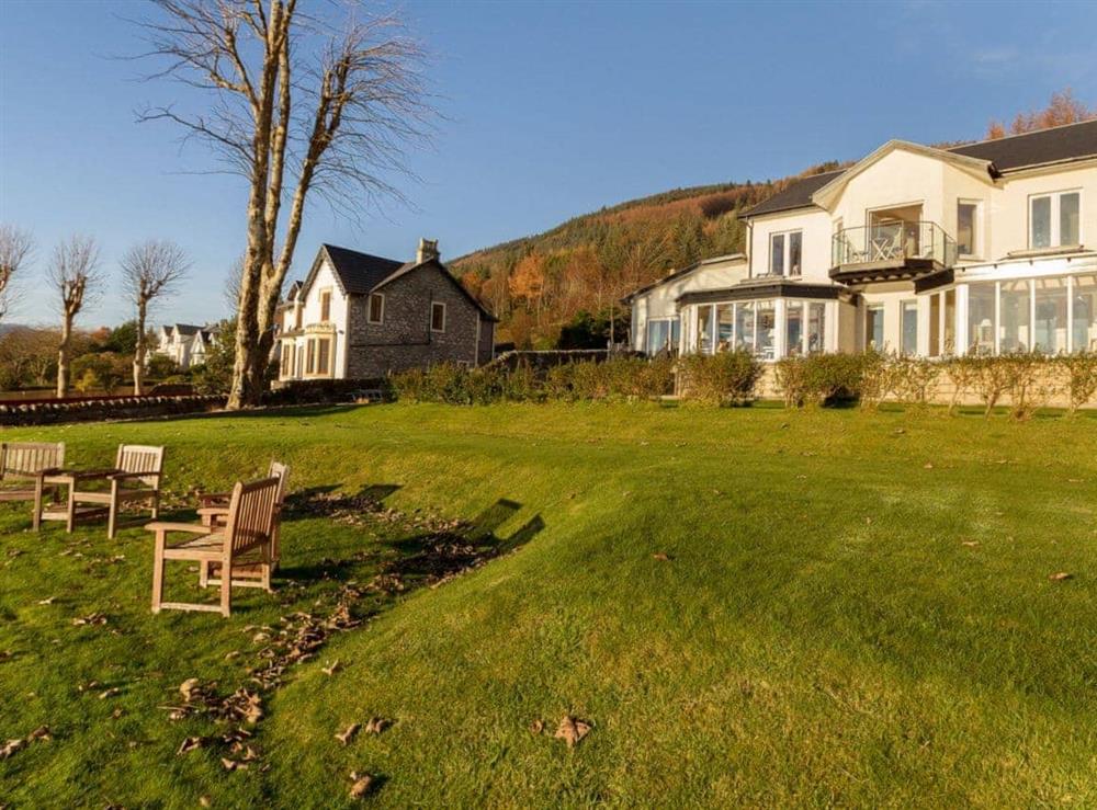 Landscaped garden reaching right to Loch Long’s edge at The Penthouse in Strone, near Dunoon, Argyll