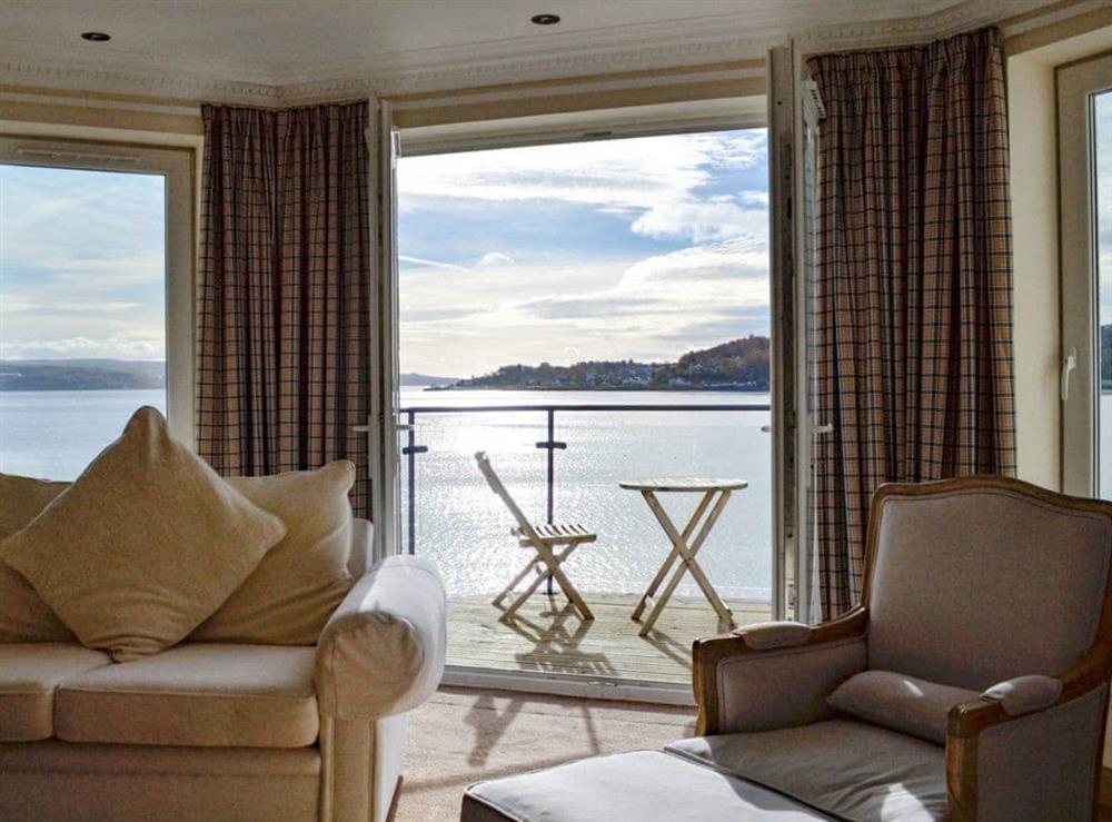 Living room with French doors opening onto balcony at The Penthouse in Strone, near Dunoon, Argyll