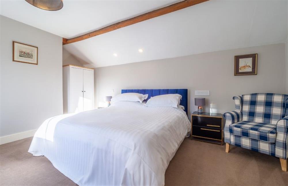 Master bedroom with a 5’ king-size bed at The Piggery, Colne Valley