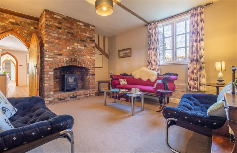 Sitting room with inglenook fireplace and electric living flame fire