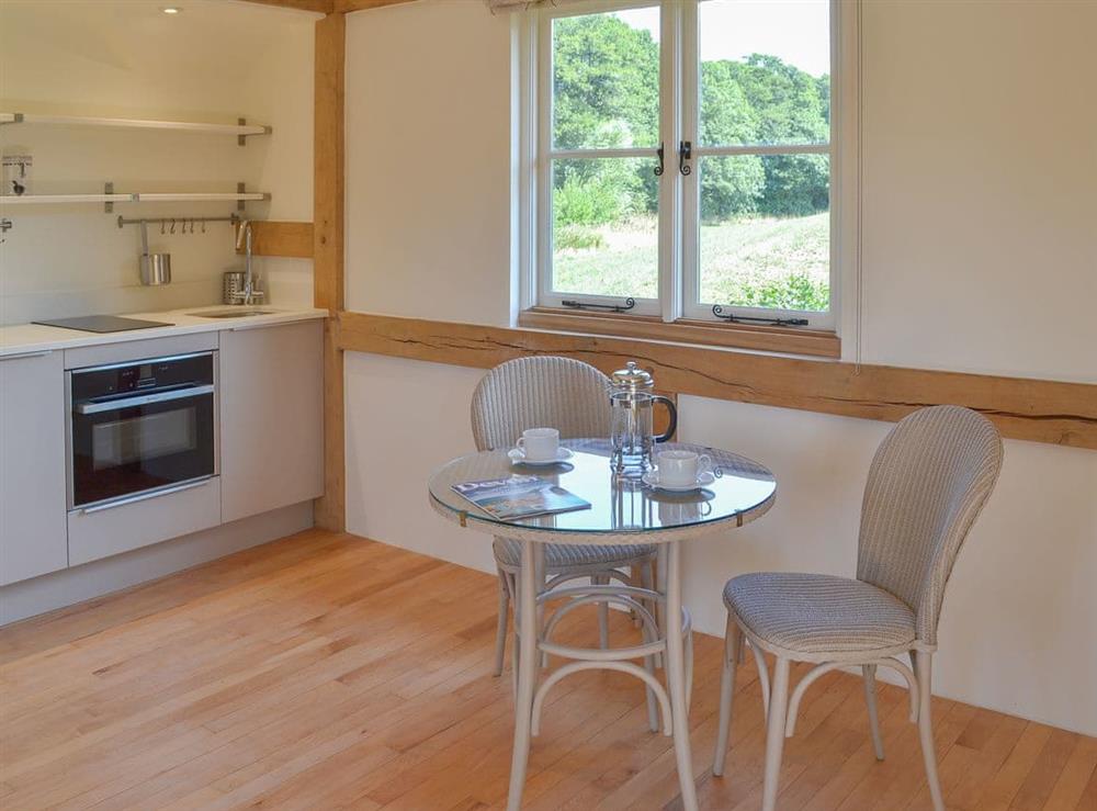 Dining area and well-appointed kitchen at The Piglet in Sidbury, near Sidmouth, Devon