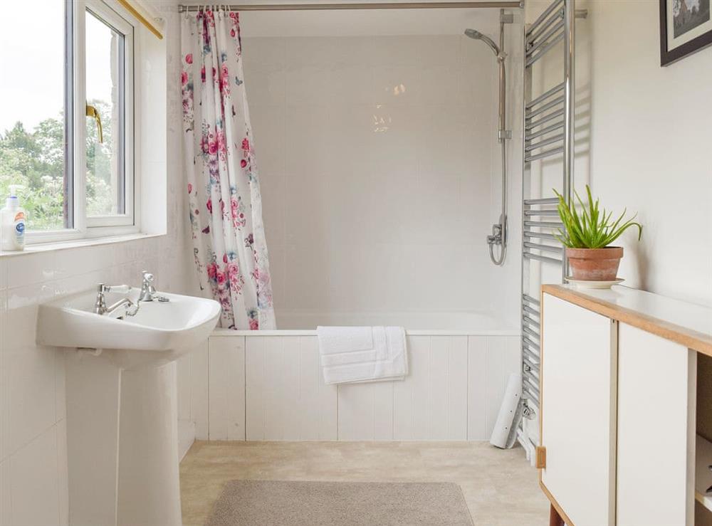 Light and airy family bathroom with shower over bath at The Plough in Bampton, near Witney, Oxfordshire