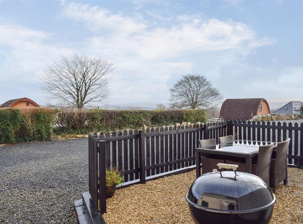 Private outdoor space with BBQ and table and chairs at The Plucking Barn in Llanwnnen, near Lampeter, Cardigan, Dyfed