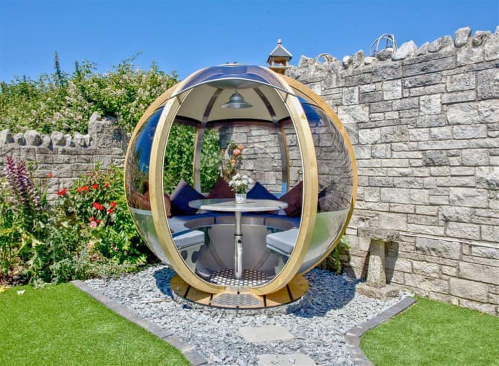 Picturesque garden with unique furniture at The Pod in Weymouth, Dorset
