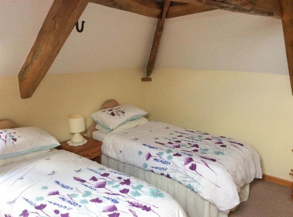 Beamed twin bedroom at The Pump House in Hawkesbury Upton, Avon
