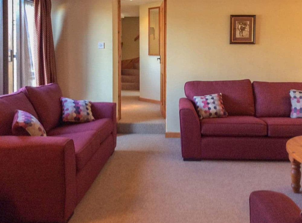 Living room with comfortable sofas at The Pump House in Hawkesbury Upton, Avon