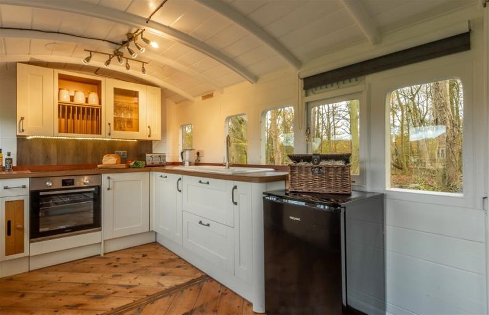 Ground floor: A fitted kitchen with a view at The Railway Carriage, Melton Constable