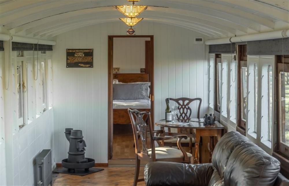 Ground floor: The sitting and dining area lead through to the bedroom at The Railway Carriage, Melton Constable