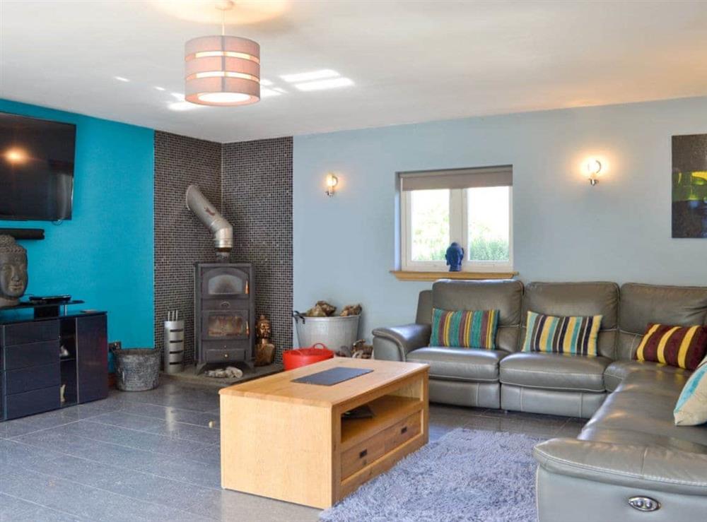 Large, comfortable living room with wood burner at The Ranch in Glen Massan, near Dunoon, Argyll