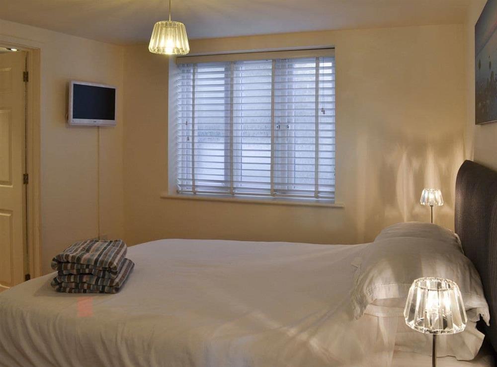 Double bedroom with wall mounted TV at The Ravine in Heybrook Bay, near Plymouth, Devon