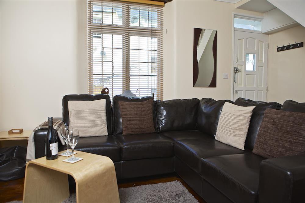 A very stylishly presented room with oak flooring, L-shaped leather sofa