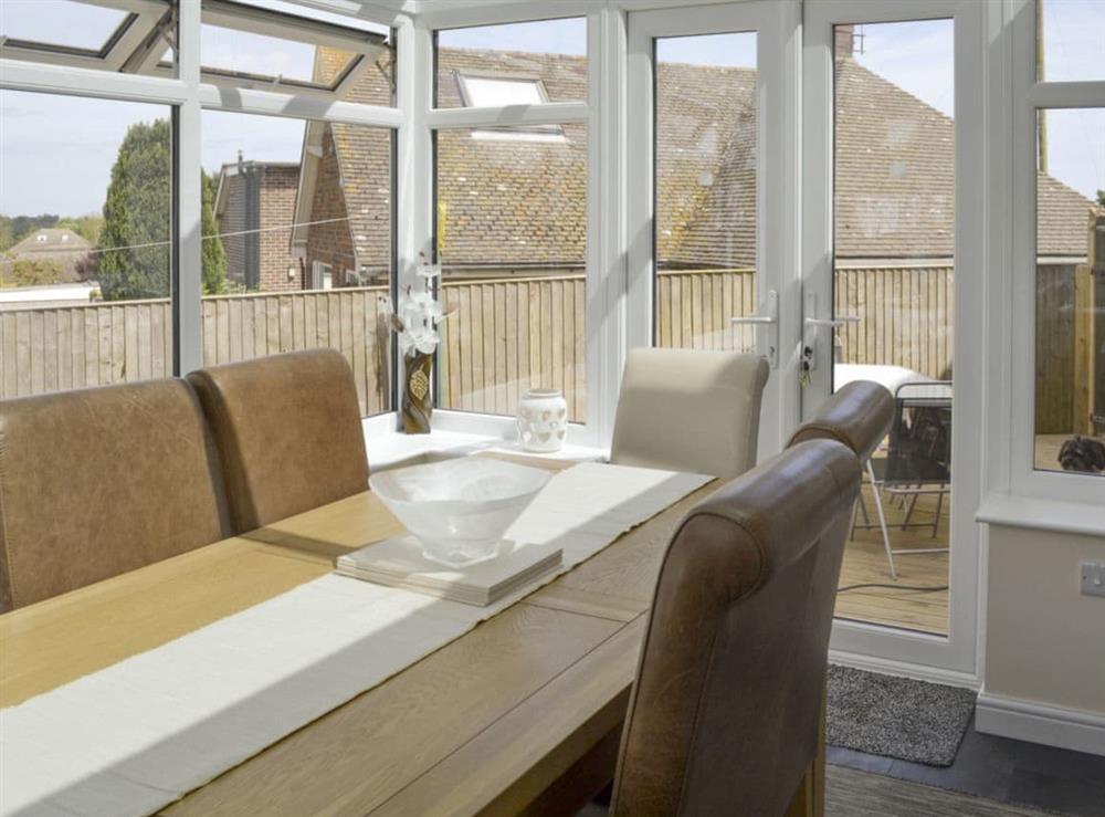 Light and airy dining space in conservatory at The Retreat in Hunmanby, near Filey, North Yorkshire
