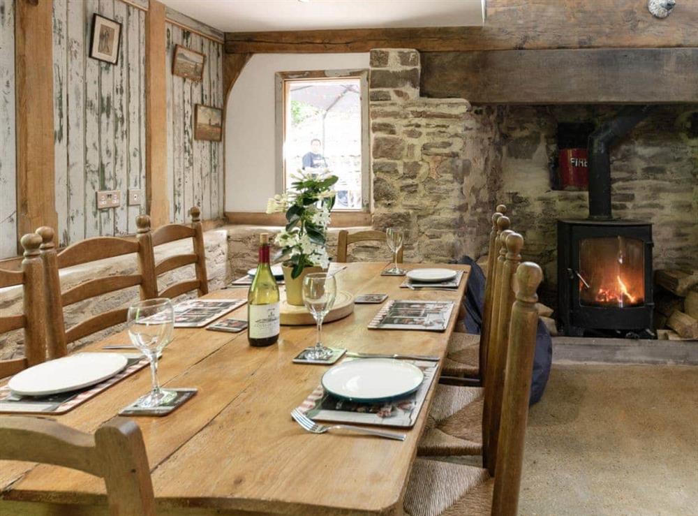 Delightful dining area featuring reclaimed wood panneling at The Retreat in Longhope, near Gloucester, Gloucestershire, England