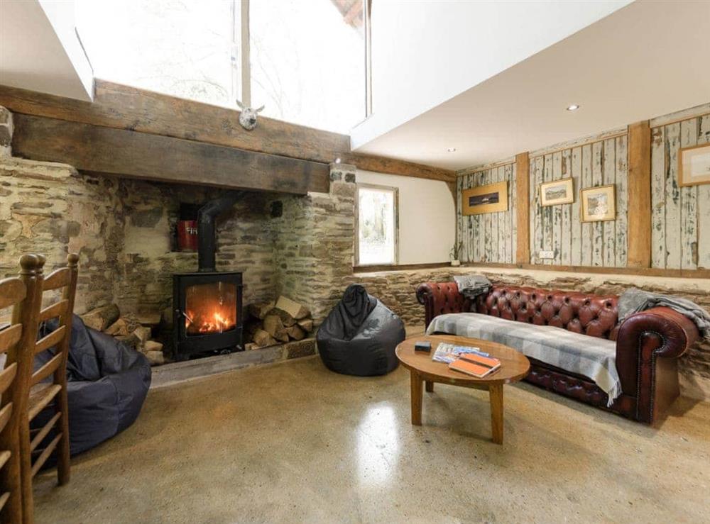 Double-height living area with wood burner at The Retreat in Longhope, near Gloucester, Gloucestershire, England