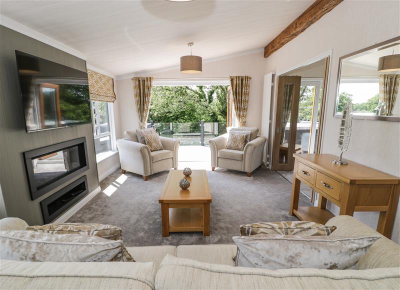 Relax in the living area at The Rivendale Lodge, Pwllheli