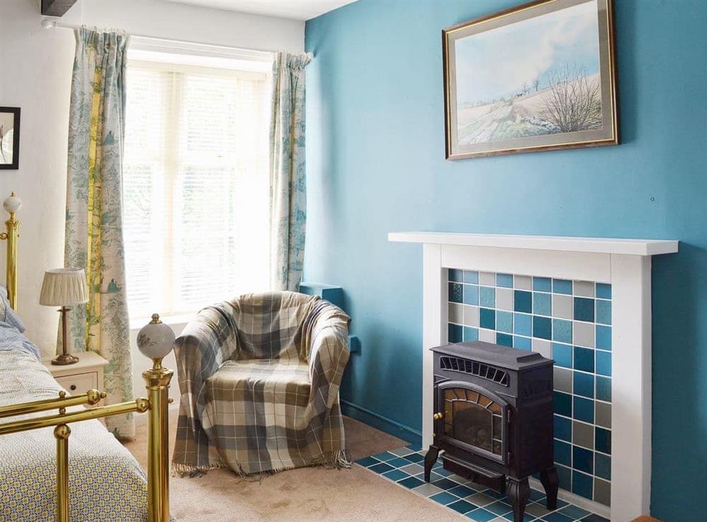 Charming double bedroom with feature fireplace at The Rockery in Shap, near Penrith, Cumbria