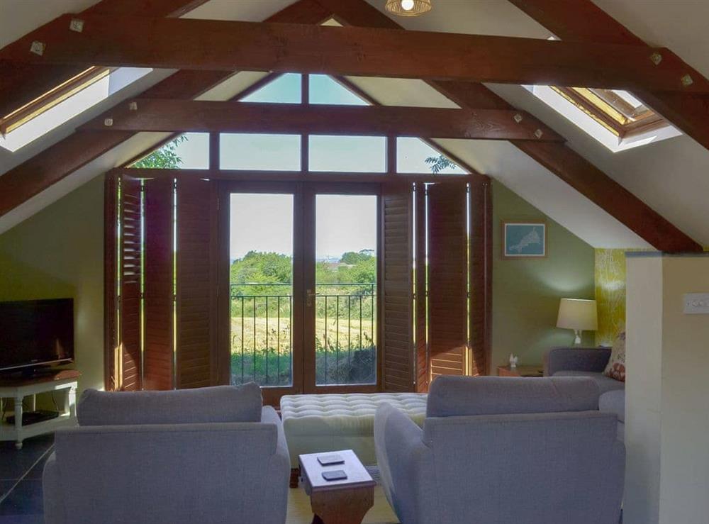 Large windows in the open plan living space offer stunning countryside views at The Roost in St. Breward, near Bodmin, Cornwall