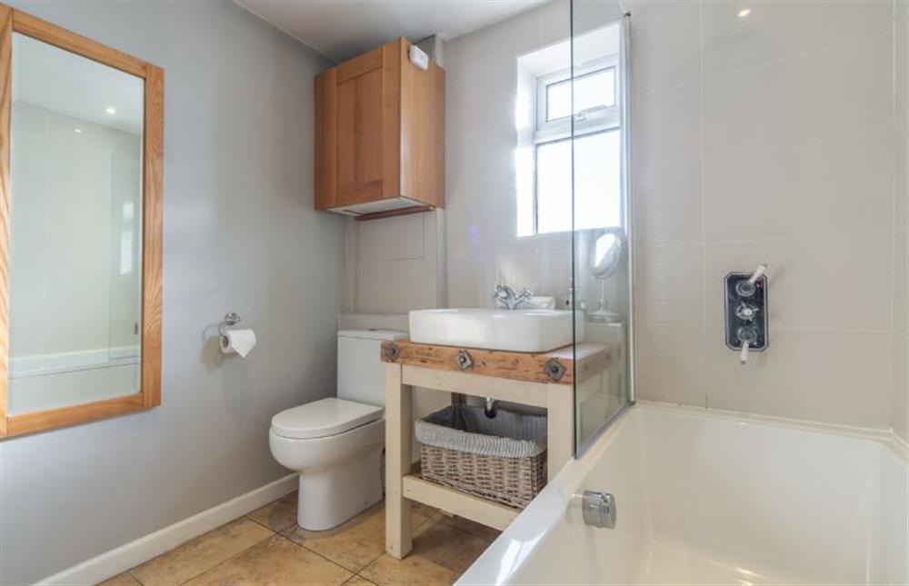 Ground floor: Modern bathroom with shower over bath at The Roost, Titchwell near Kings Lynn