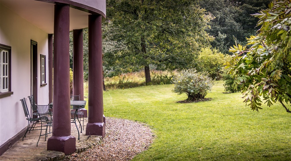 The portico, covered patio and garden lawn at The Round House in Bury St Edmunds, Suffolk